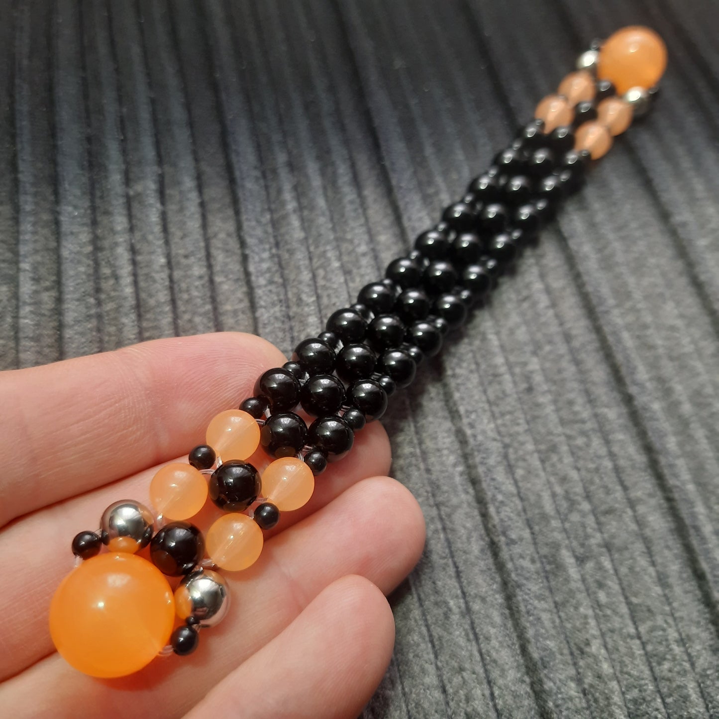 Handmade flip rosary (chetki), assembled from round plastic beads. The chotki has good flexibility thanks to the silicone cord. This fidget is used as an anti-stress, skill toy, stylish accessory and collectible.