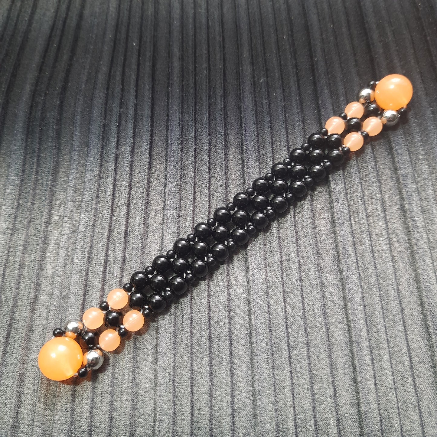 Handmade flip rosary (chetki), assembled from round plastic beads. The chotki has good flexibility thanks to the silicone cord. This fidget is used as an anti-stress, skill toy, stylish accessory and collectible.